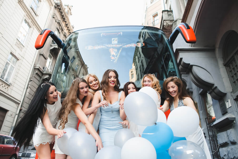 party buses or limos - young women outside the bus