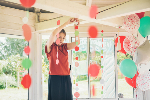 woman hanging party decorations